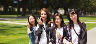 Four VSP students pose outdoors on campus