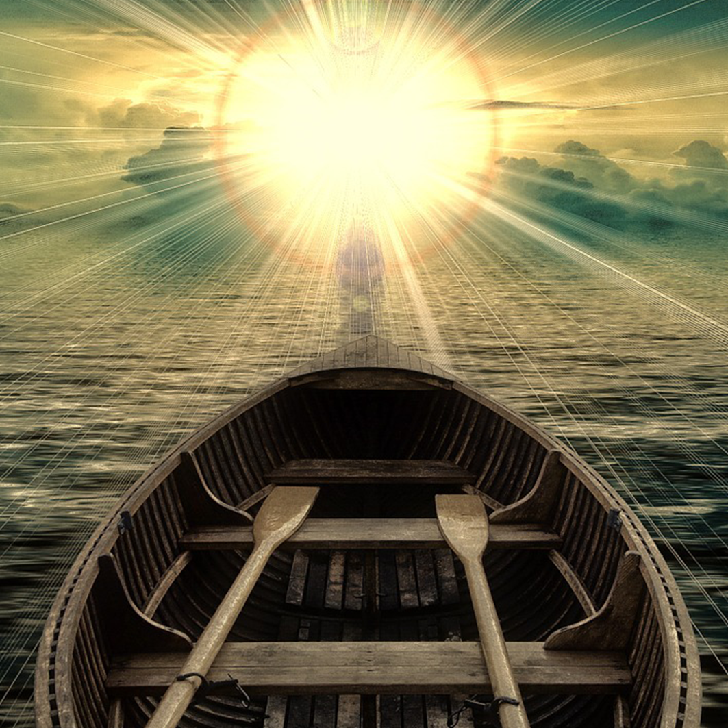 Rowboat with shipped oars is oriented toward setting sun 