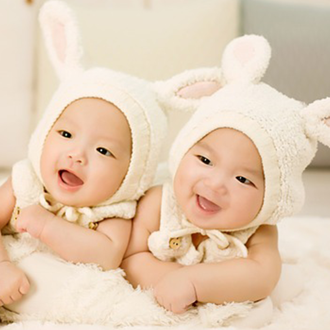 Twin babies in bunny hats