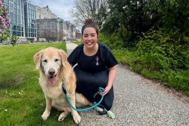 Dr. Rachel Ollivier with golden retriever and King Charles III Coronation Medal