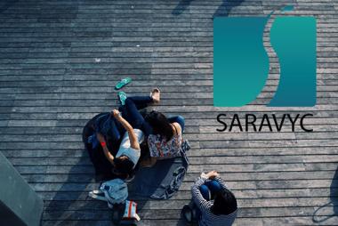 SARAVYC logo superimposed over aerial shot of people on boardwalk
