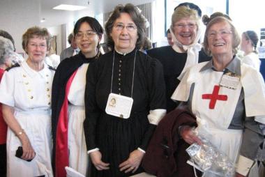 Five members of BCHNS wearing historical nursing uniforms
