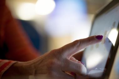woman's hand using ipad