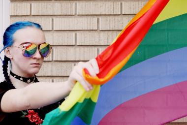 Slide of woman holding pride flag