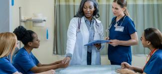 Adjunct instructs student nurses in clinical setting
