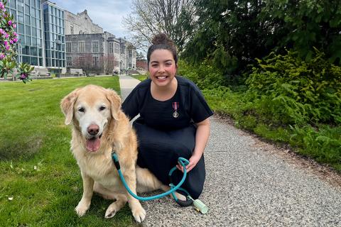 Dr. Rachel Ollivier with golden retriever and King Charles III Coronation Medal
