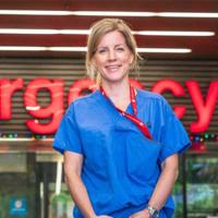 Lara Gurney Stands in front of Hospital